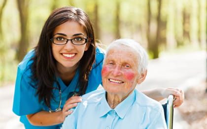 Parkinson's Patient in wheelchair with caregiver