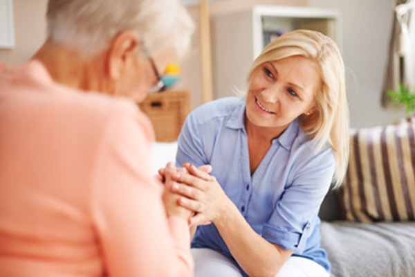 Multiple Sclerosis patient sitting with her caregiver