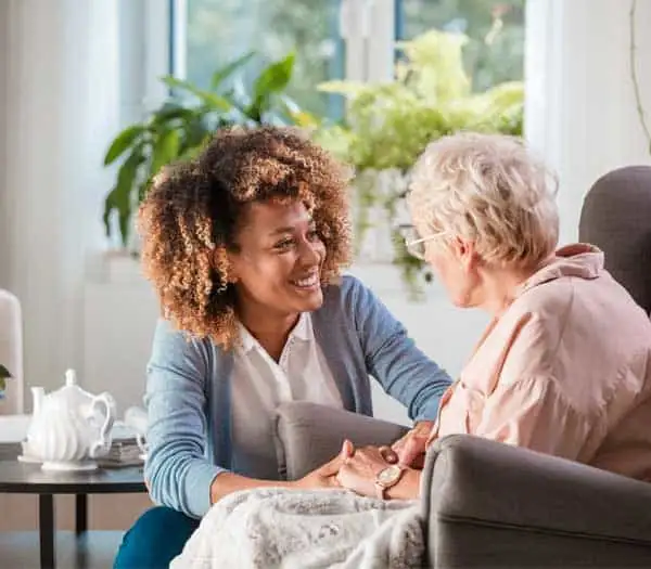 Caregiver talking to elderly woman