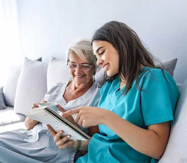 Caregiver assisting elderly woman